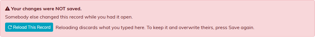 The red record banner reading Your changes were NOT saved, Somebody else changed this record while you had it open, with a Reload This Record button